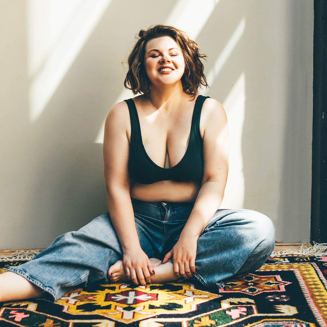 Woman sitting on the floor smiling